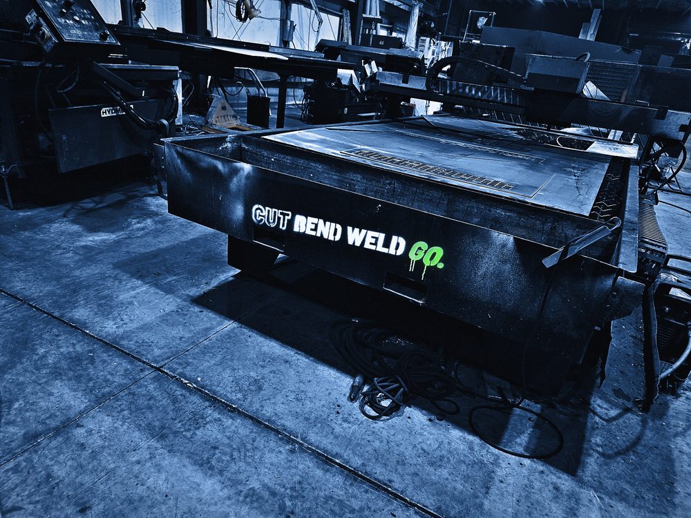 The plasma table with the logo sprayed along its side