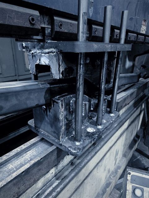 A welded setup with upright rods sitting in the press brake