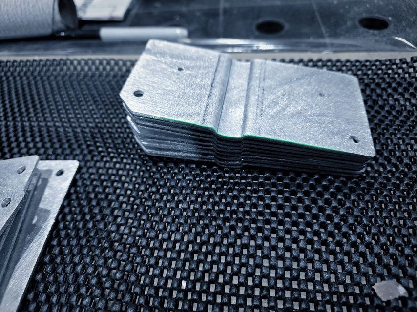 A stack of plates with a pressed dimple and stepped edges