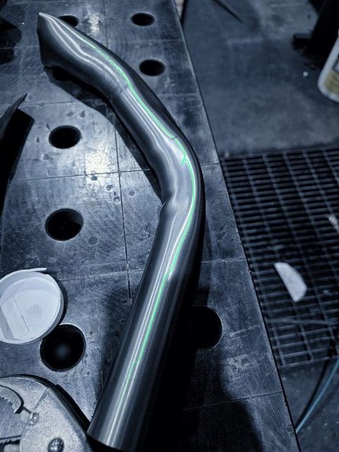 A bent tube lying on the fixture table