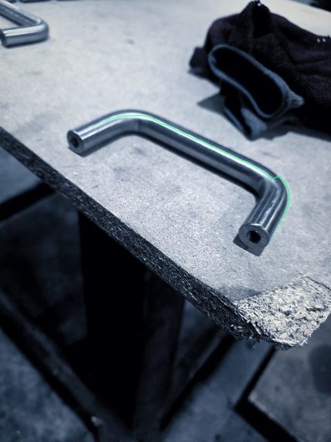 A single bent handle on the edge of a table