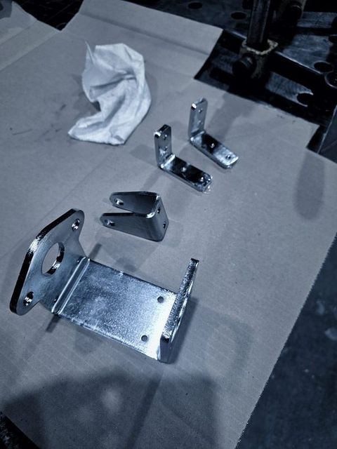 Small bright brackets laid out on cardboard